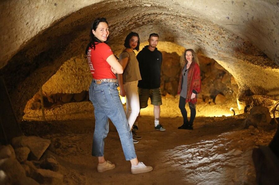 a group of people standing in a cave